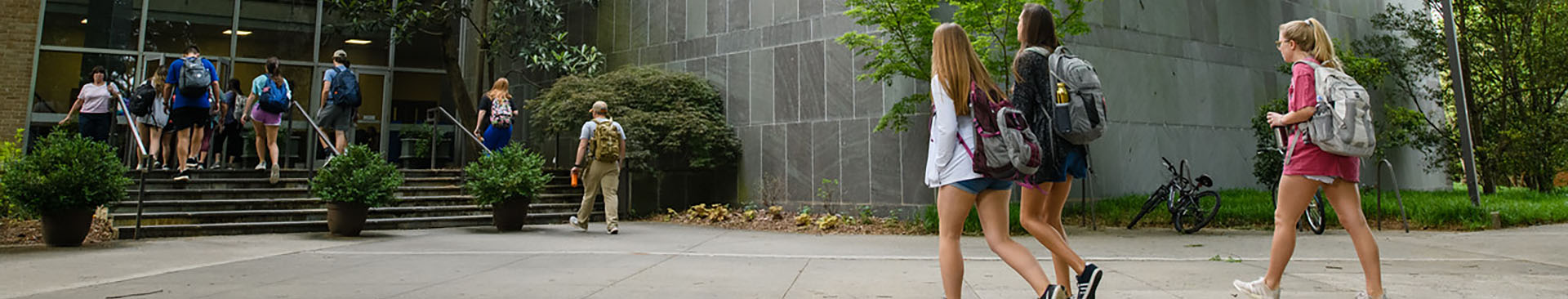 students walking into the pool and agriculture building