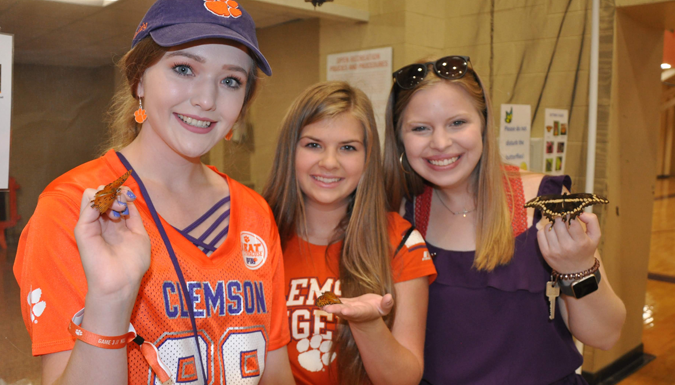 clemson students holding butterflies