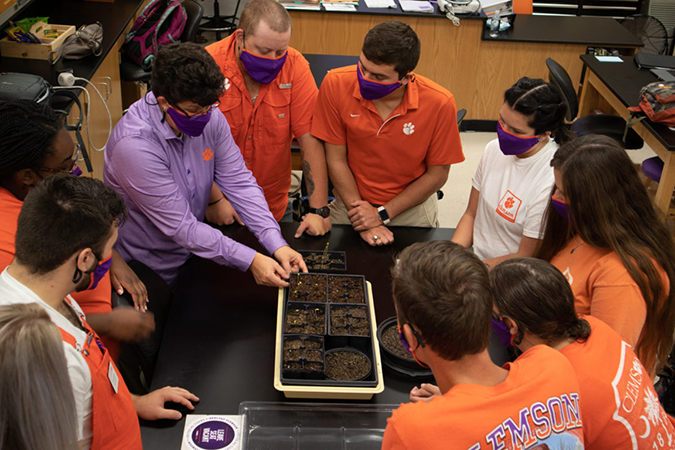 students learning about soil from professor