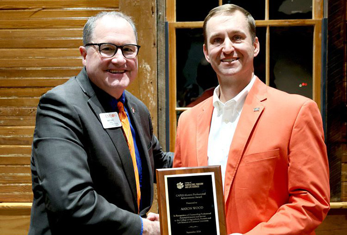 The CAFLS dean Matt Holt shaking hands with Aaron Wood