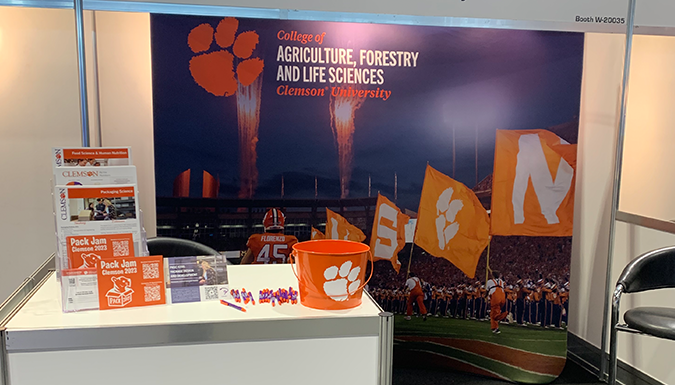 display table with college branded signs and handouts