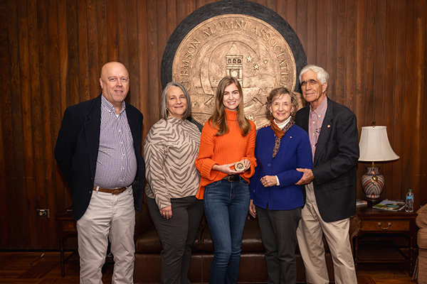 members of the Clemson Alumni association posing with a Clemson ring