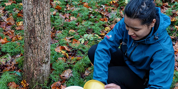 person squatting in field