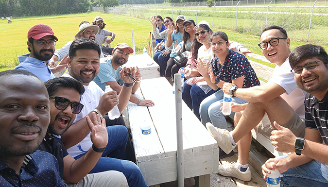 group of graduate students at an outdoor table 