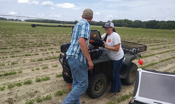 farmers working in field by a four wheeler