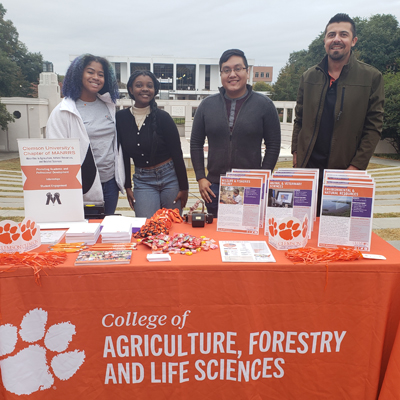 manrrs-students-at-campus-event-booth-
