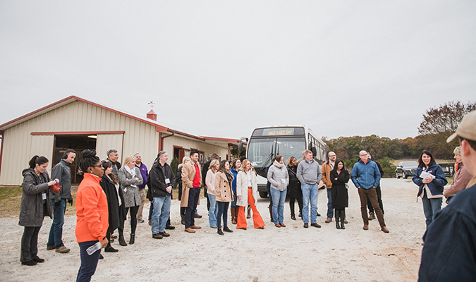 group of people on a tour of the equine center