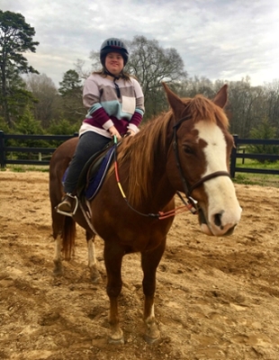 girl riding tebow during CLEAT event