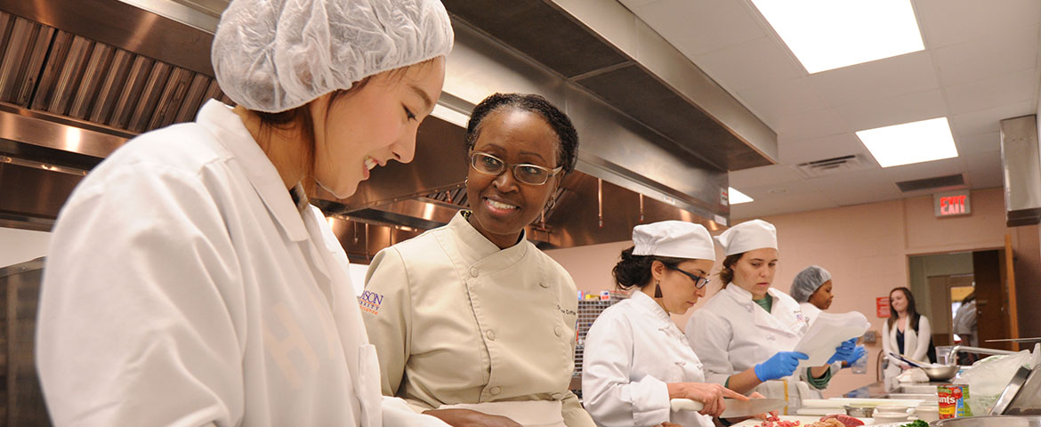 Food Nutrition students smiling while working in the kitchen