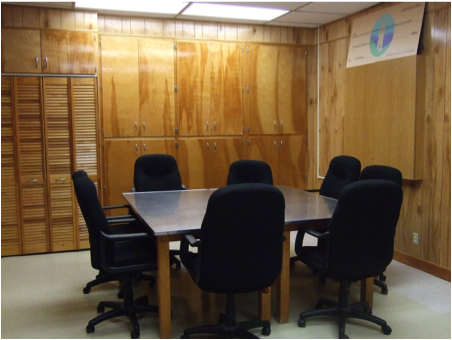 a table with eight chairs in the resource area of the sensory lab