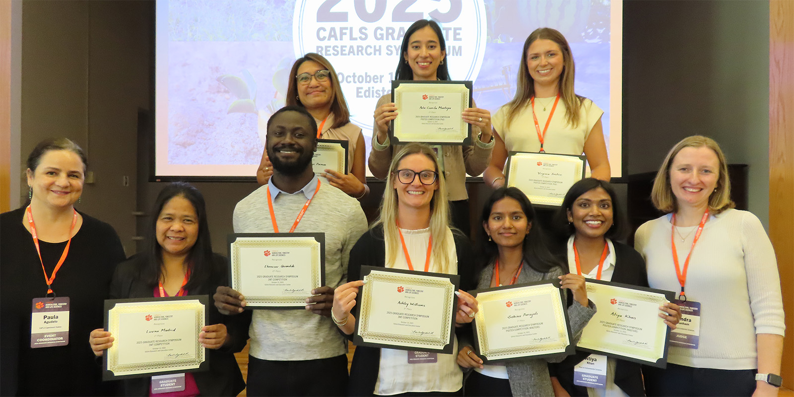 group photo of the graduate symposium winners holding their awards