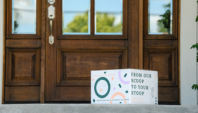 box of ice cream delivered on the front step of a beautiful home