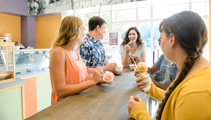 Group of smiling coeds eating ice cream at Clemson Ice Cream.