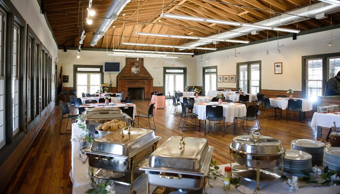 large room with tables and buffet set up for a meal