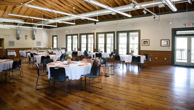 large room with tables and buffet set up for a meal