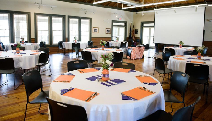 large room with tables and buffet set up for a meal