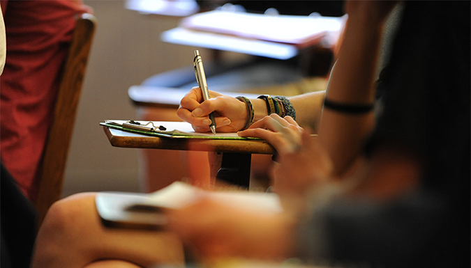 student writing at desk