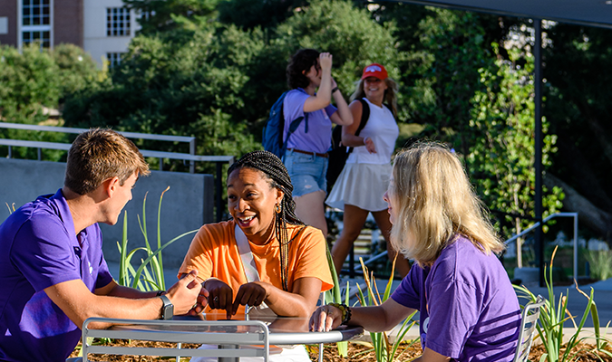 students walk on Clemson's campus near Daniel Hall