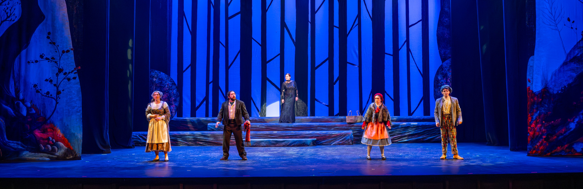 Production photo from the Clemson Players production of Into the Woods. Five actors stand onstage.