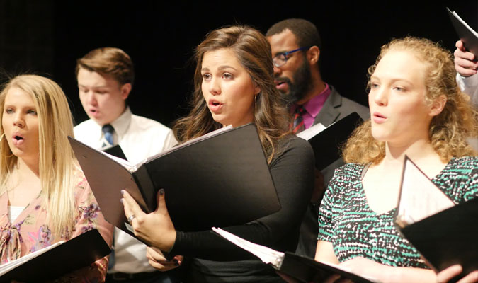 Members of Cantorei hold music and sing