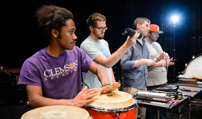 Percussion ensemble plays instruments on stage