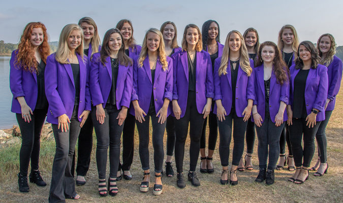 Members of Takenote pose in purple jackets