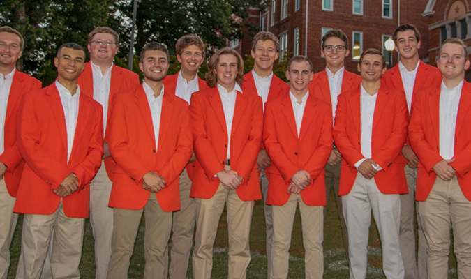 Members of Tigeroar pose in orange jackets