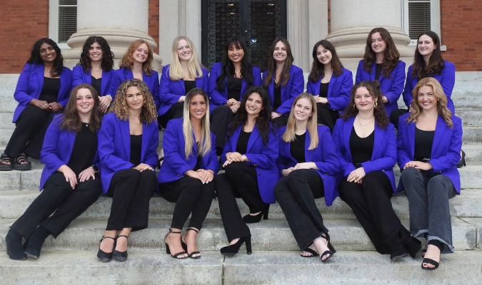 Members of Takenote pose in purple jackets