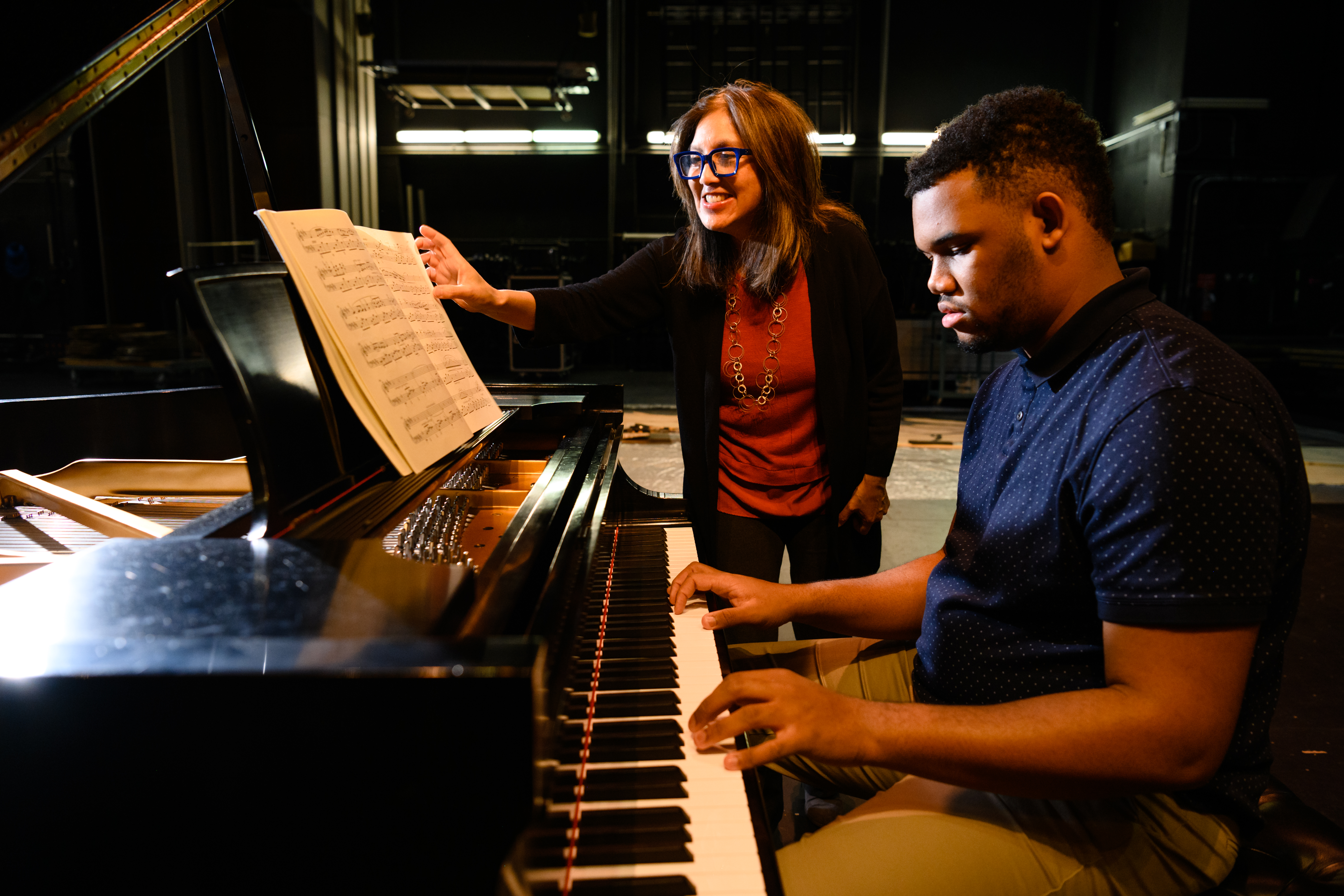 Linda Li-Bleuel instructs student Christmas Walker on a Steinway piano on the Brooks Stage