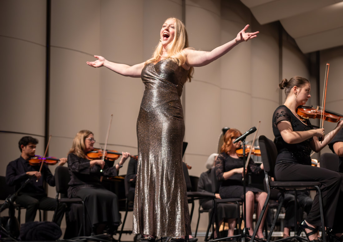 a vocalist performs with a string orchestra