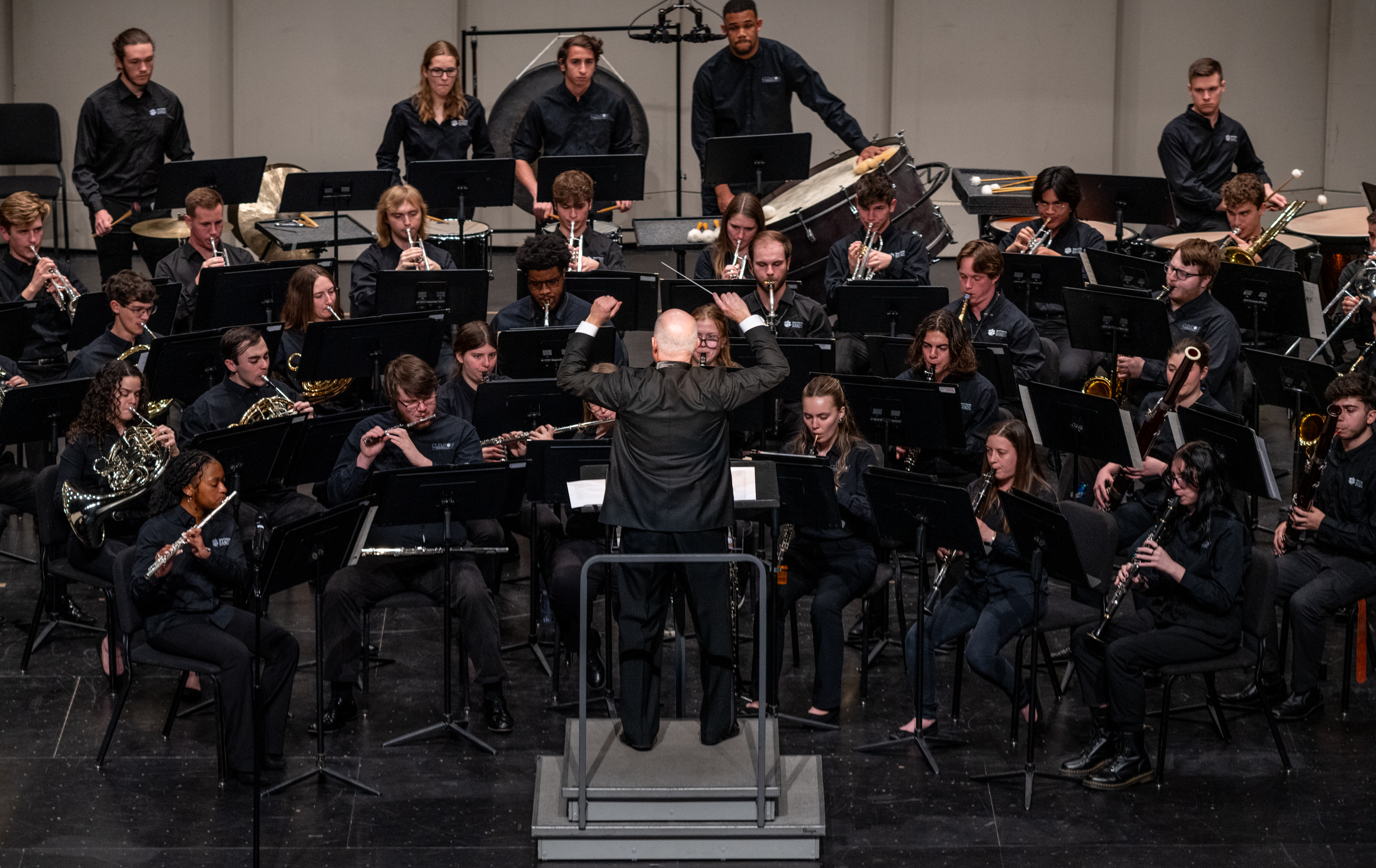 a large musical ensemble performs onstage