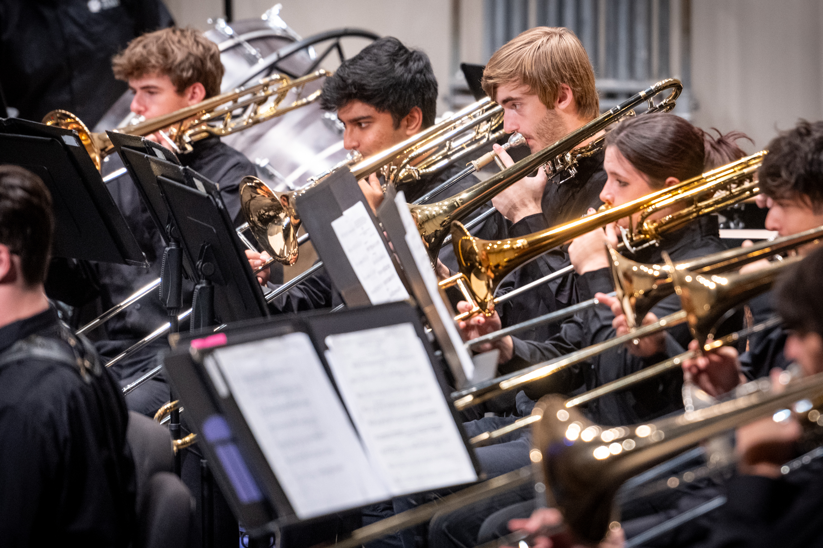 close-up of the trombone section playing during a concert