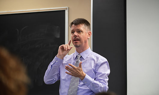 Man communicating using American Sign Language
