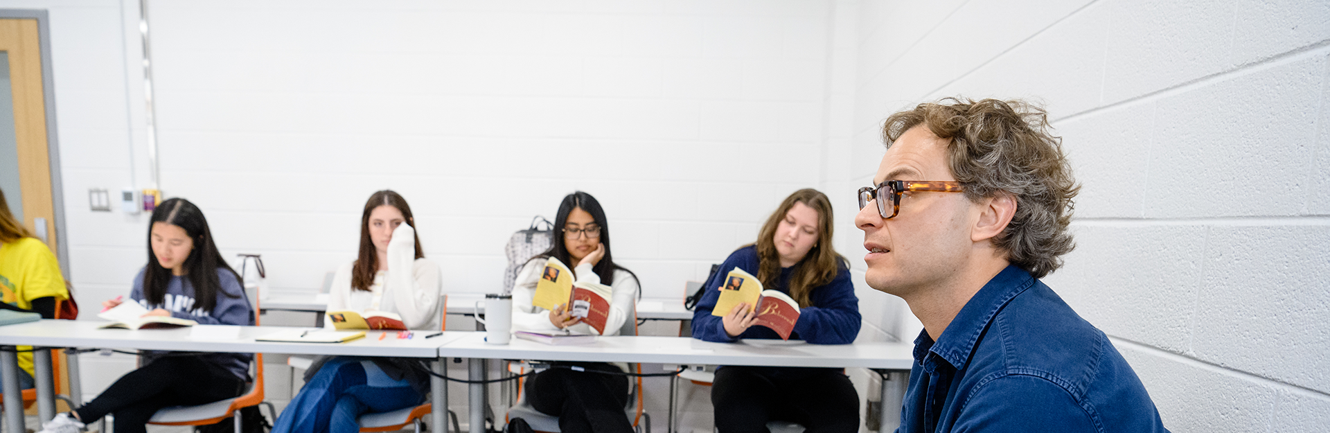 A classroom of students reading and talking