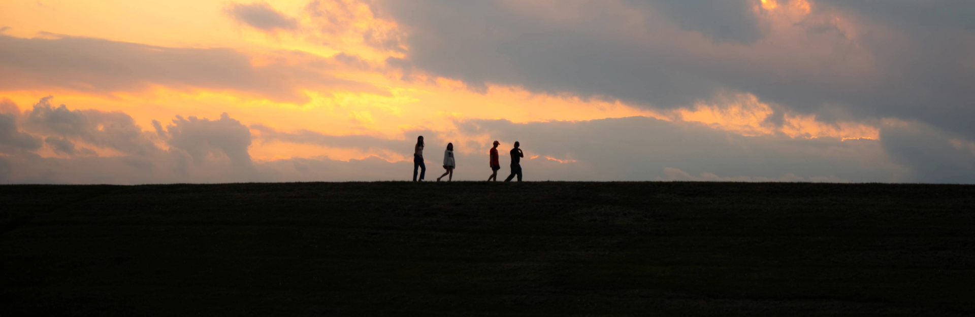People walking along a distant horizon