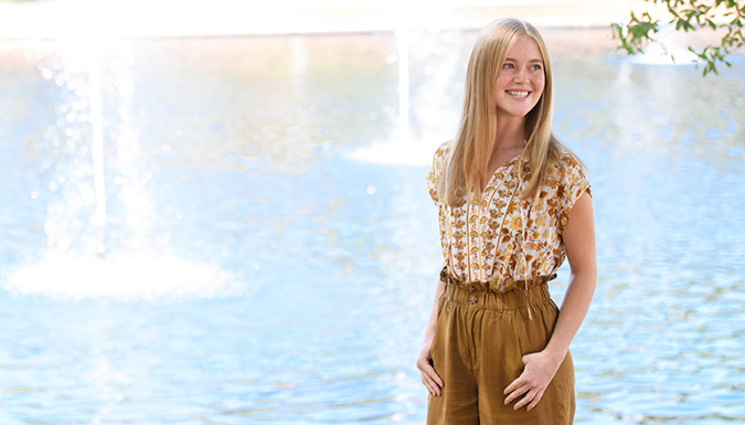 Natalie Claypool stands in front of a fountain