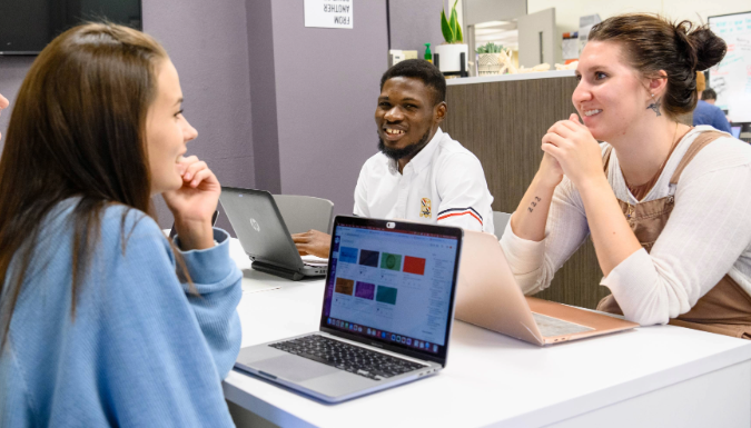 Students sitting around a table talking