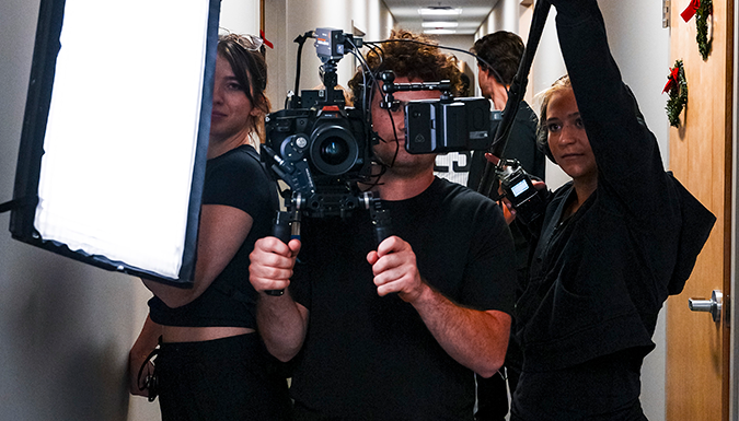 people holding camera equipment