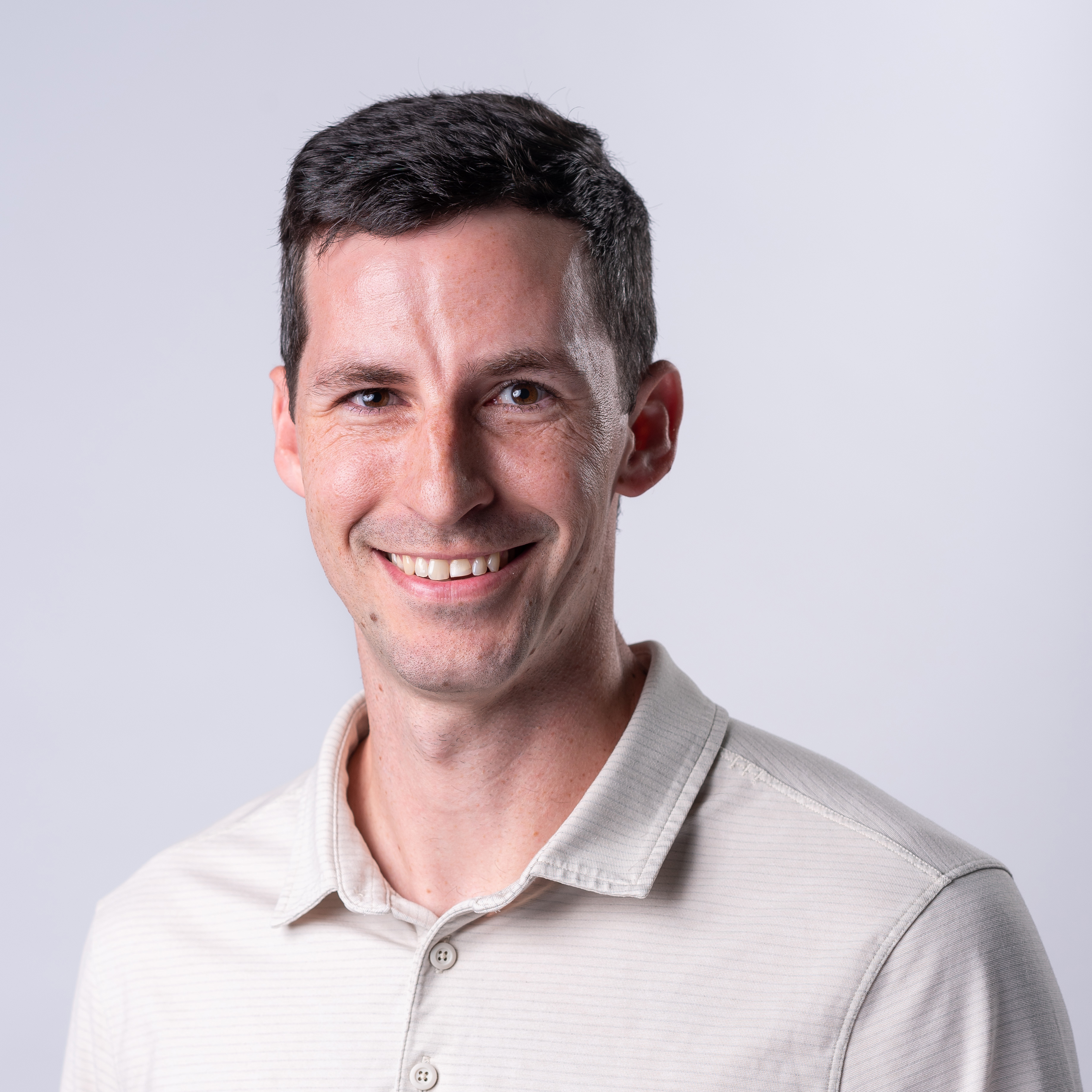 A person in a white shirt in front of a white background