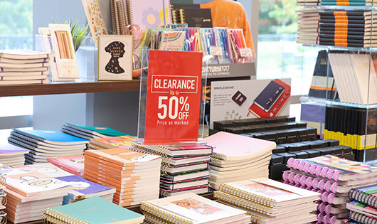 Table of books with a clearance 50% off sign