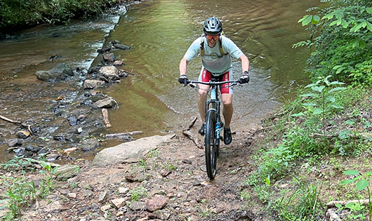 mountain biker crossing water