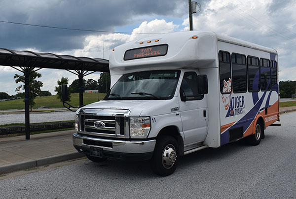 Park-N-Ride bus with marquee displayed is waiting at that bus stop.