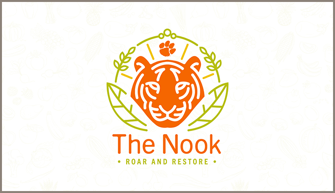 icon of orange tiger surrounded by green filigree with The Nook written in orange