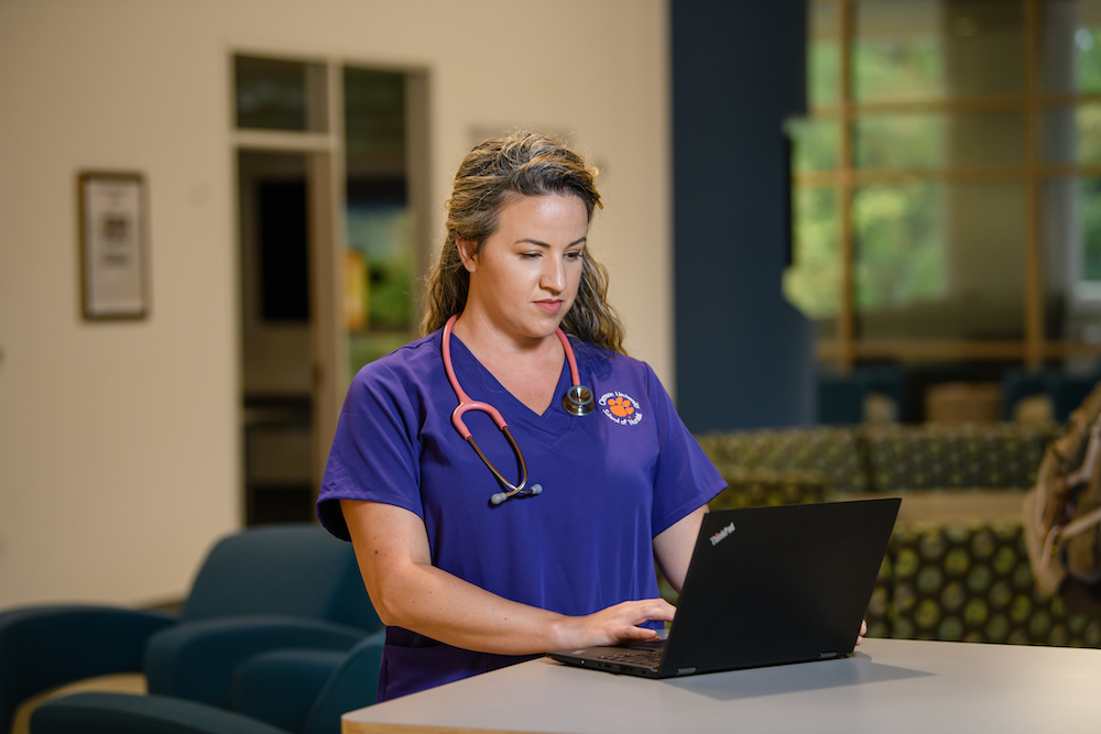 Clemson University School of Nursing student typing on a laptop