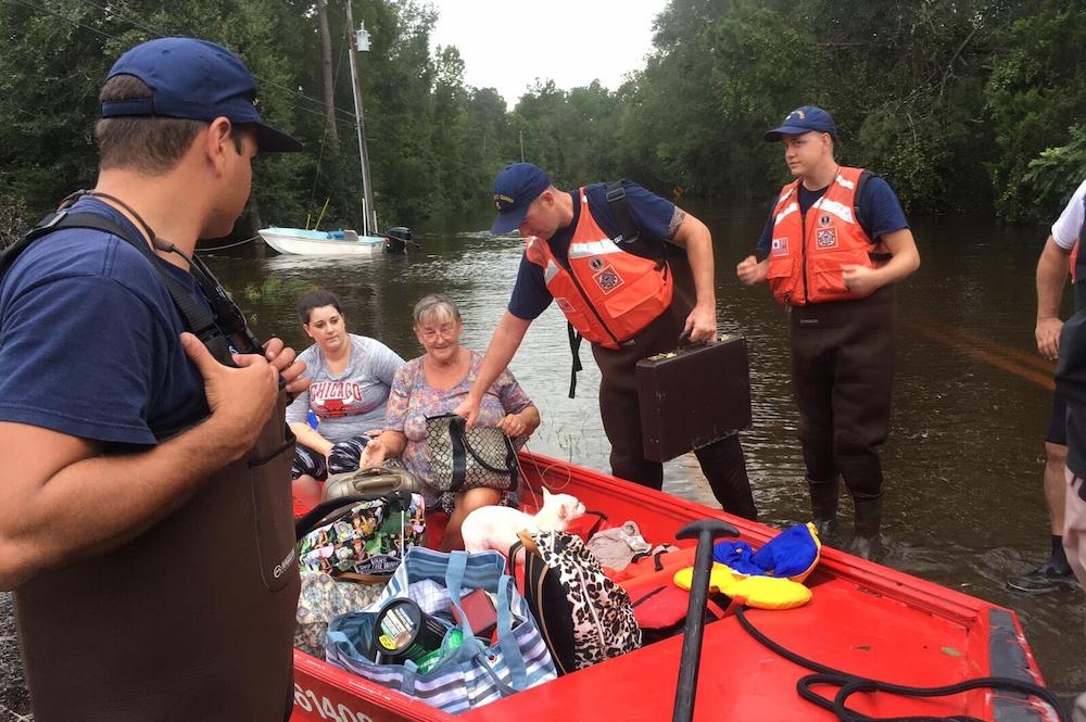 Image of a woman being rescued in a boat