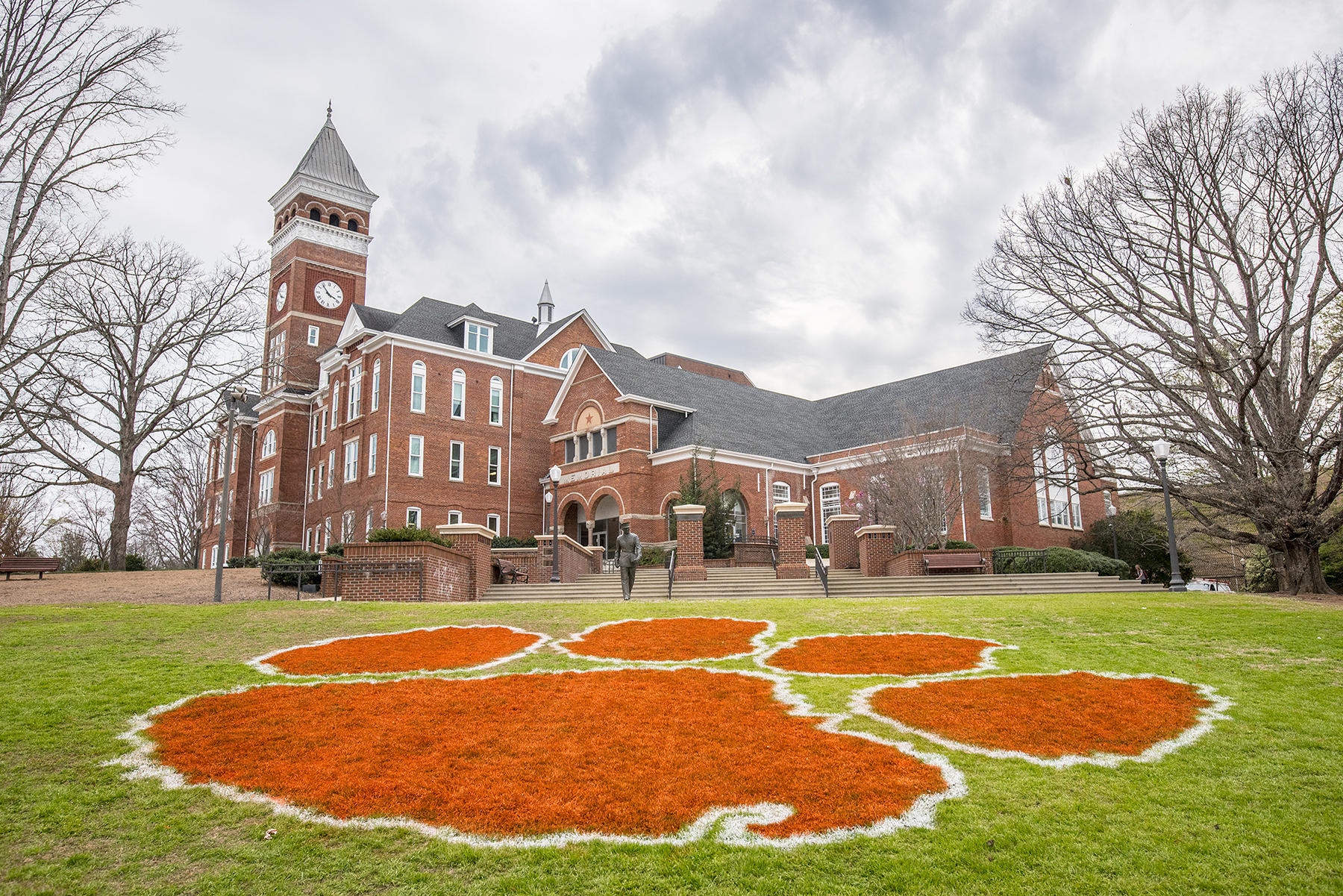 A painted Tiger Paw on Bowman Field by the Old Main building on campus.