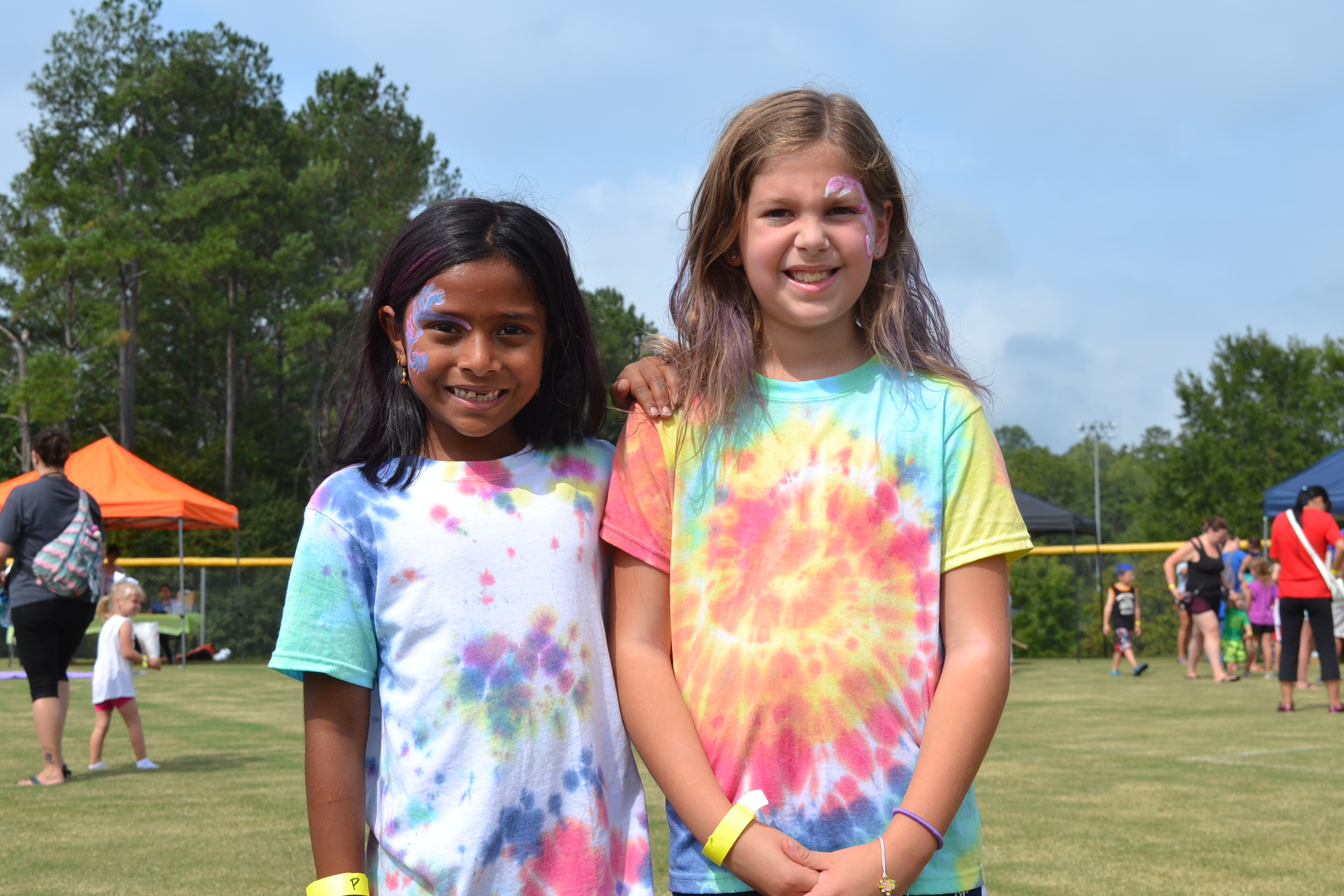 Photo of two young girls smiling at the camera.