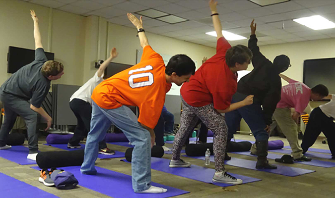 Photo of people doing yoga indoors.