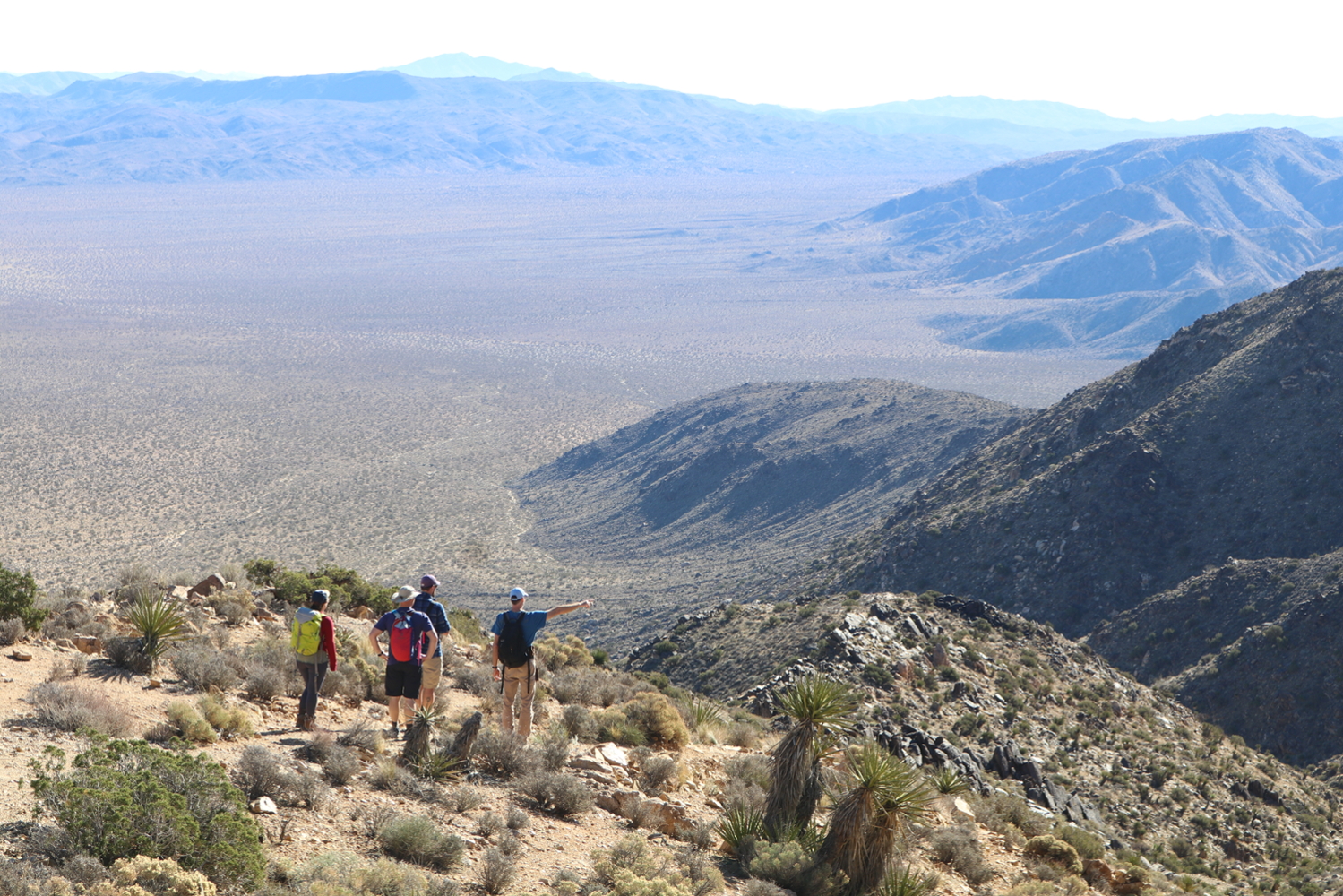 Picture of a group of people looking over a mountain range.