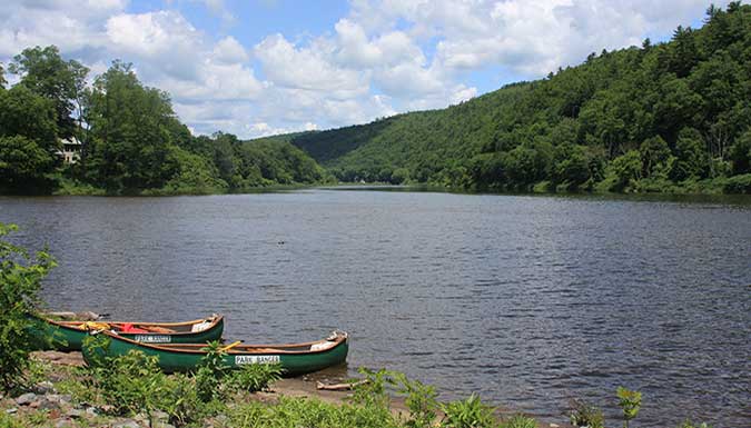 Photo of kayaks on the shore of a lake.